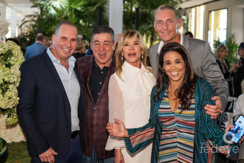 Itchko Ezratti wife and family members, including Misha Ezratti, posing with friends at a philanthropic event in Florida.