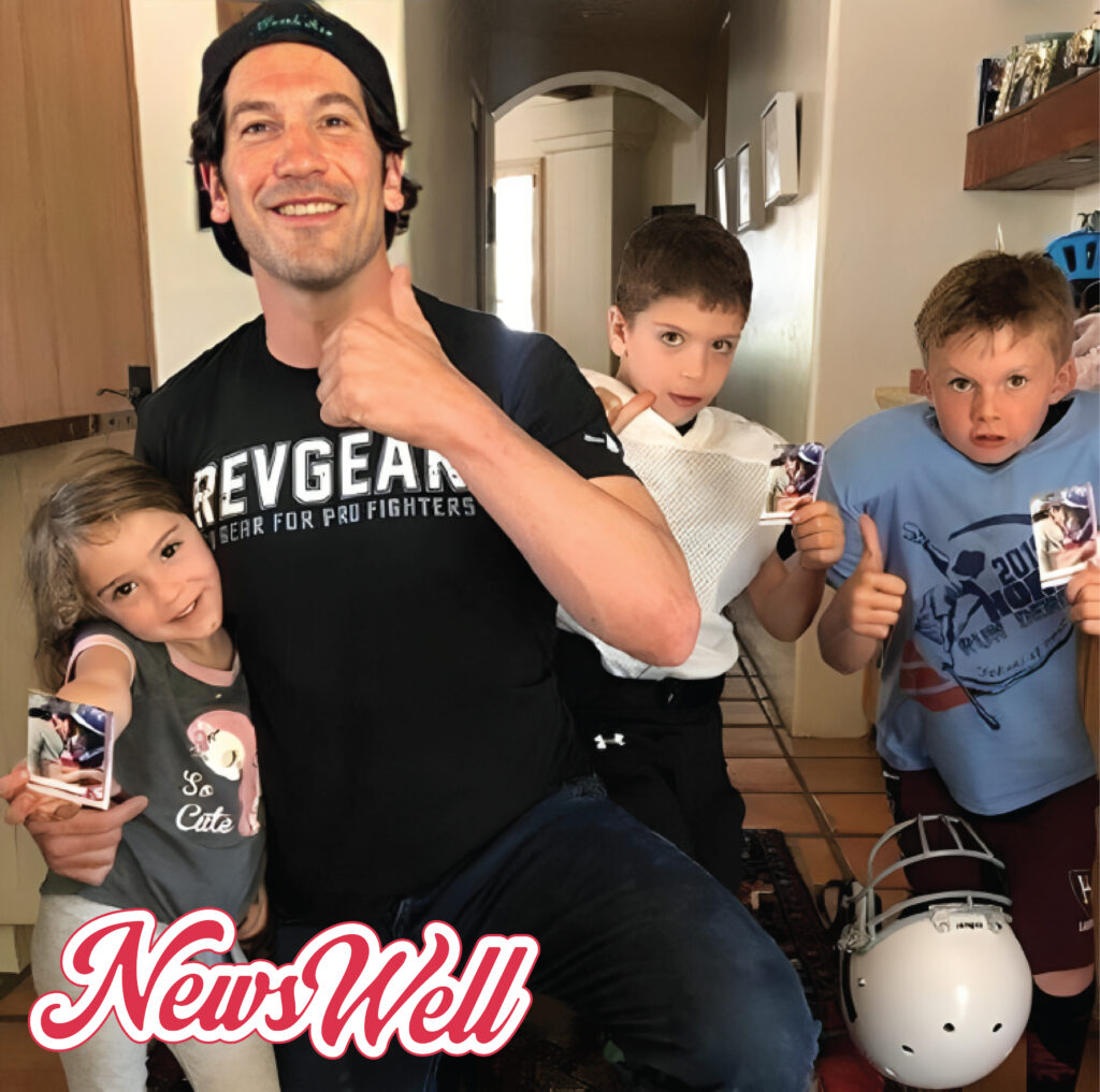 A playful, candid photo of Jon Bernthal at home giving a thumbs-up with his three children: daughter Adeline, son Henry, and eldest son Billy Bernthal, who is also giving a thumbs-up.